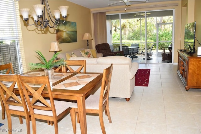 dining room featuring ceiling fan with notable chandelier and light tile patterned floors