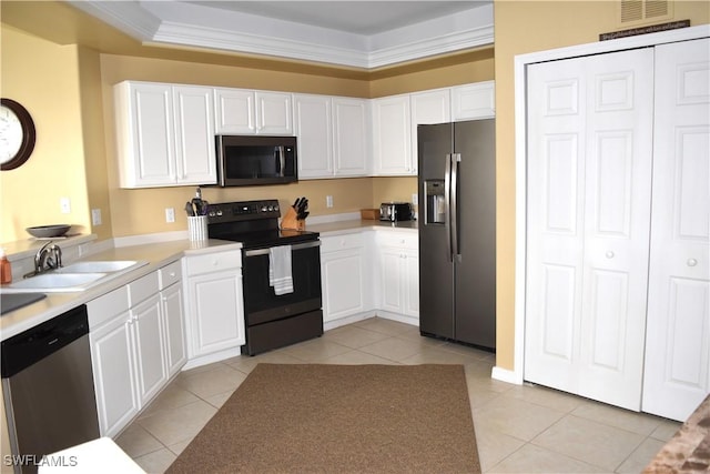 kitchen featuring light tile patterned floors, sink, appliances with stainless steel finishes, white cabinetry, and ornamental molding