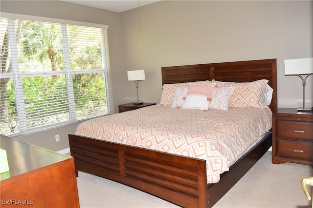 bedroom featuring light carpet