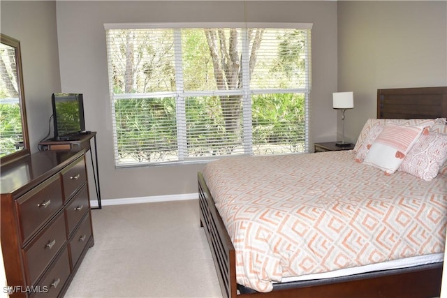 bedroom featuring light carpet