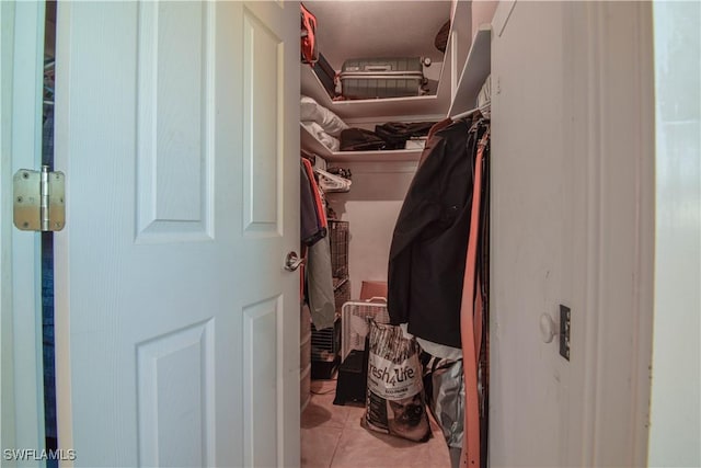 spacious closet with light tile patterned floors