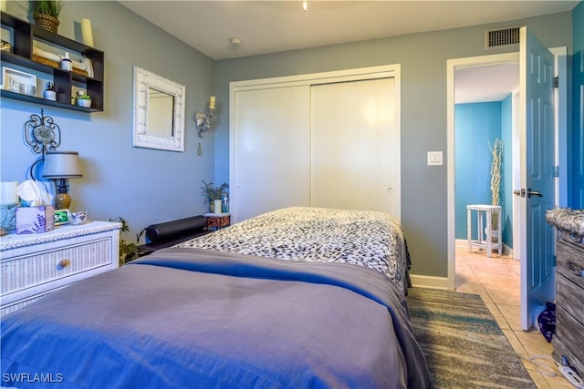 tiled bedroom featuring a closet