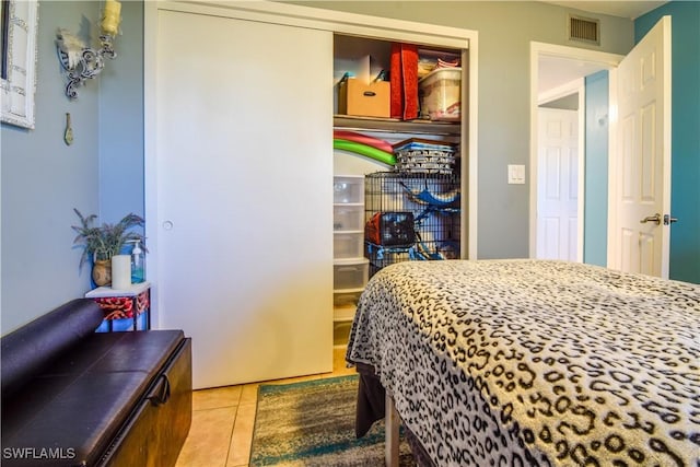 tiled bedroom with a closet