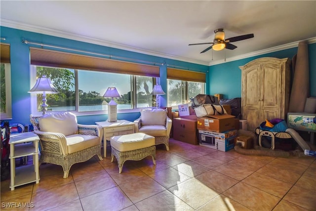 living area featuring tile patterned flooring, ornamental molding, and ceiling fan