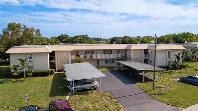 exterior space featuring a carport and a yard