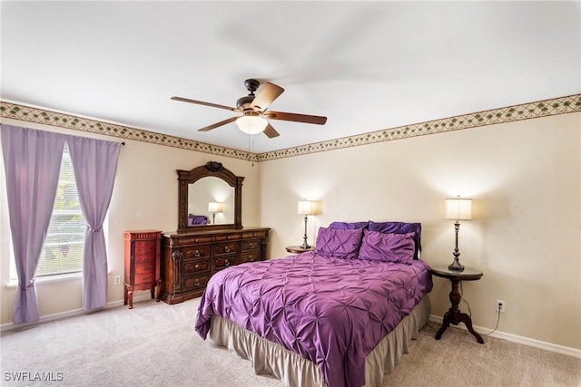 bedroom featuring ceiling fan and light carpet