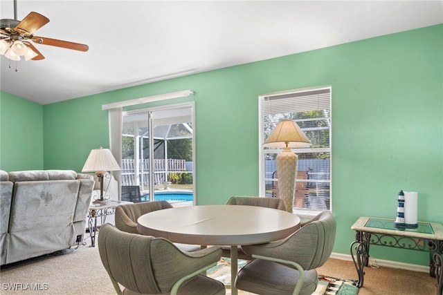 carpeted dining area featuring ceiling fan