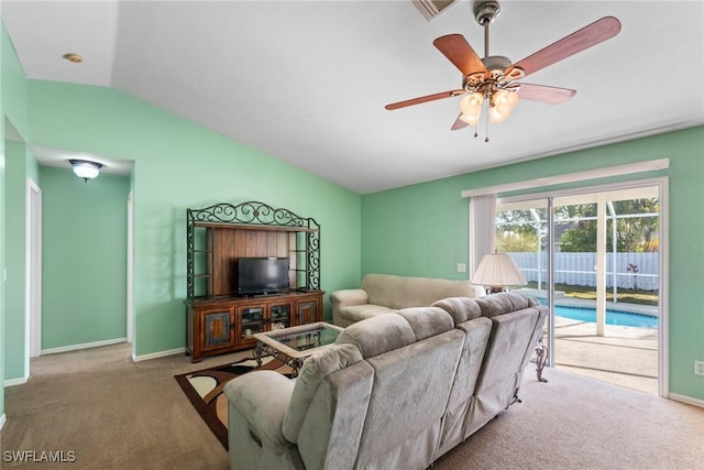 carpeted living room featuring ceiling fan and lofted ceiling