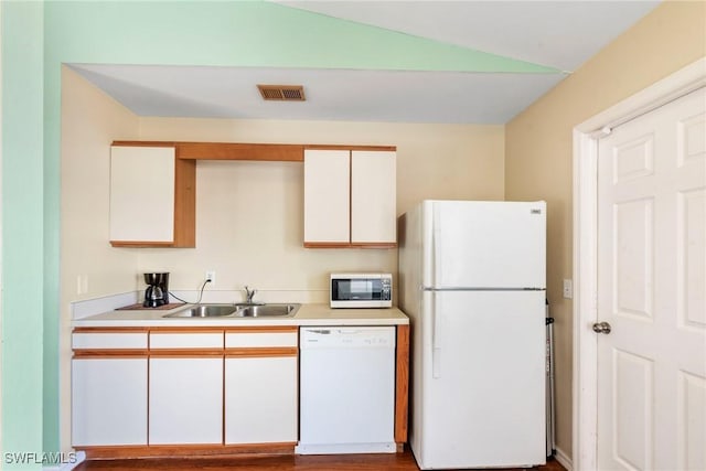 kitchen featuring white cabinetry, sink, white appliances, and lofted ceiling