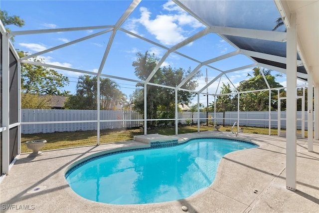 view of swimming pool with a patio and glass enclosure