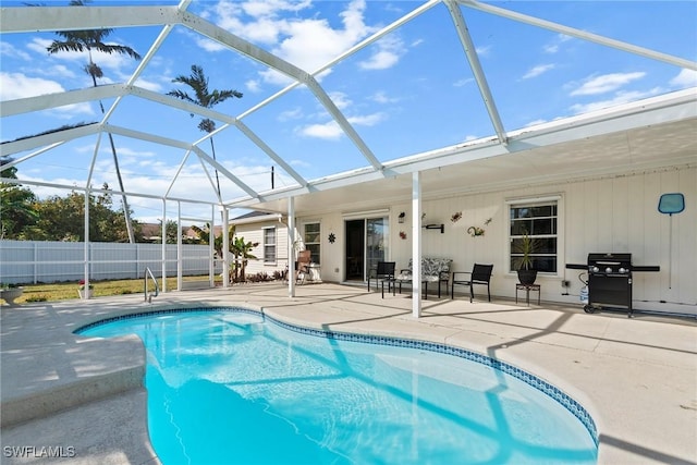 view of swimming pool featuring a lanai and a patio