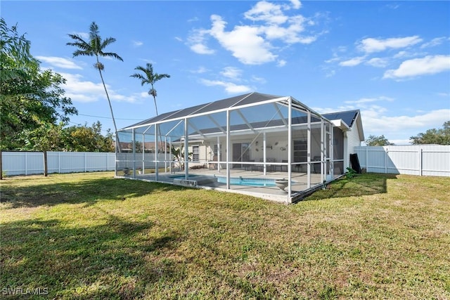 back of property featuring a fenced in pool, a patio, a lanai, and a yard