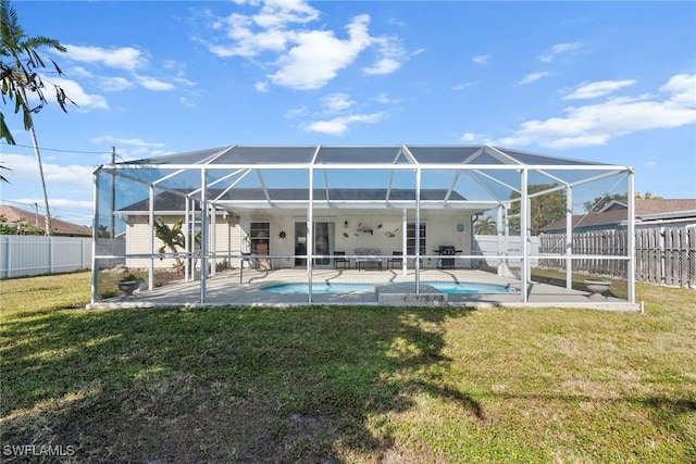 back of property featuring a fenced in pool, a yard, a patio area, and glass enclosure