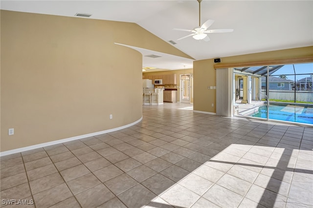 tiled spare room featuring lofted ceiling and ceiling fan