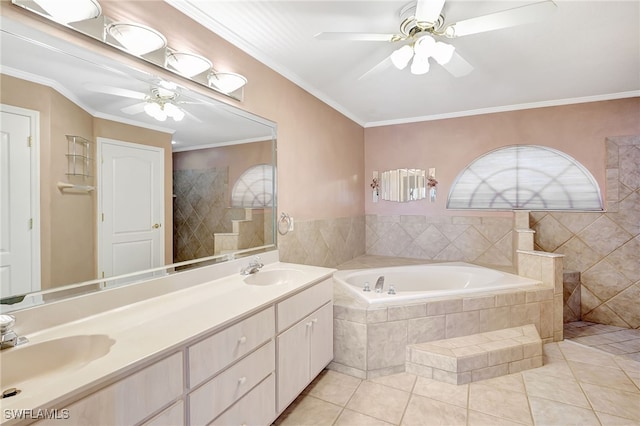 bathroom with tiled tub, crown molding, ceiling fan, tile patterned flooring, and vanity