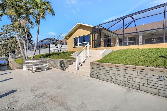 exterior space with a lanai and a patio