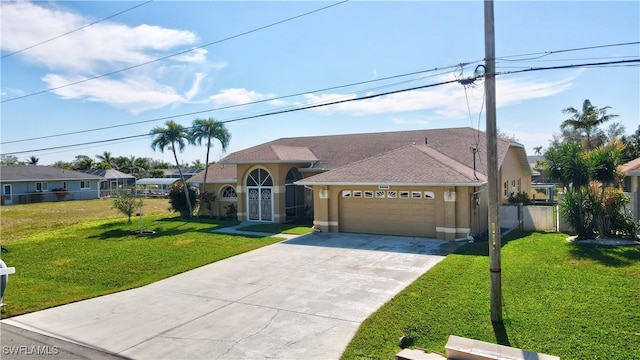 view of front of home with a garage and a front lawn