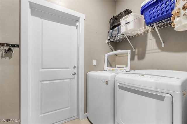 washroom featuring washer and clothes dryer