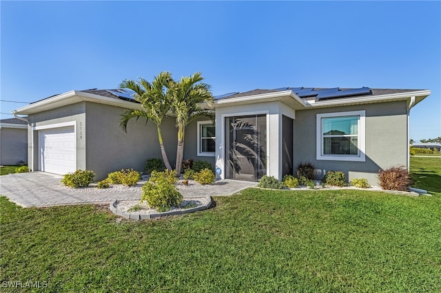 single story home featuring a garage, a front lawn, and solar panels