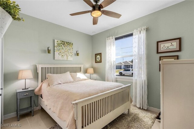 bedroom featuring light tile patterned flooring and ceiling fan