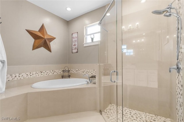 bathroom with shower with separate bathtub