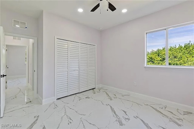 unfurnished bedroom featuring ceiling fan and a closet