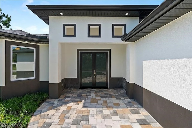 view of exterior entry featuring a patio and french doors