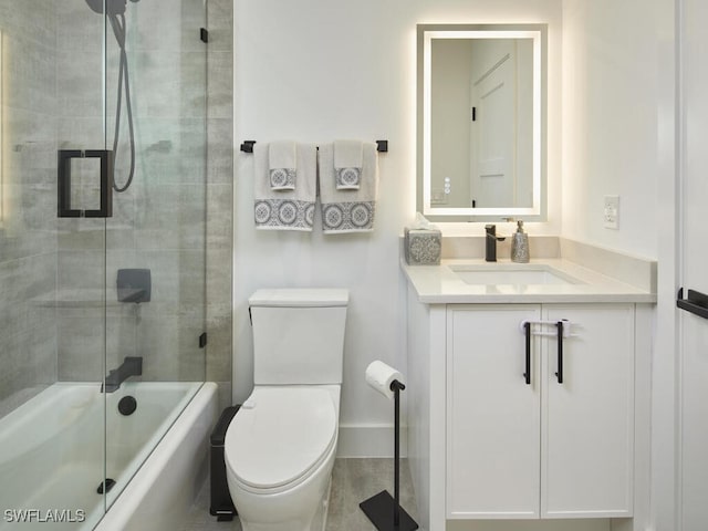 full bathroom featuring vanity, enclosed tub / shower combo, and toilet