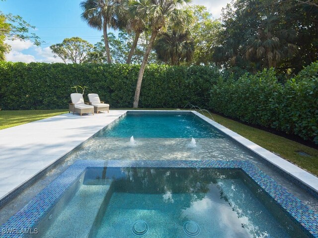 view of swimming pool featuring pool water feature and an in ground hot tub