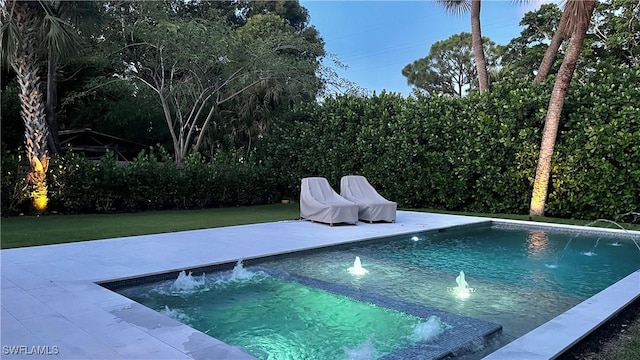 view of pool featuring a fenced in pool, a patio, and a lawn