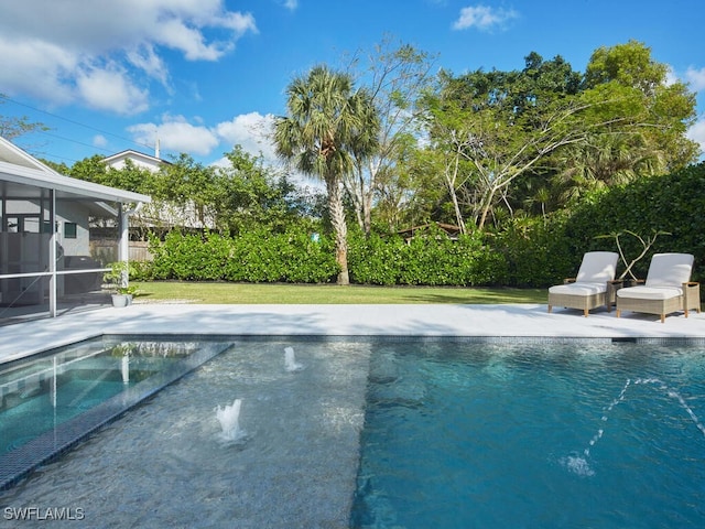 view of swimming pool featuring a yard, a patio, a sunroom, and a fenced in pool