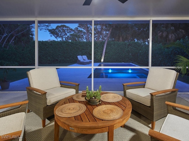 sunroom / solarium featuring ceiling fan