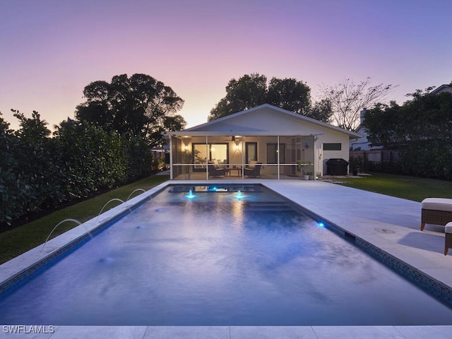 pool featuring ceiling fan, a patio, a yard, and a sunroom