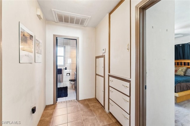 corridor with light tile patterned floors