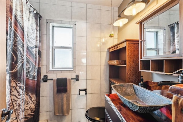 bathroom featuring tile walls and vanity