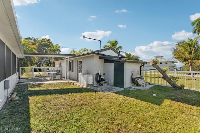 back of property featuring a lawn