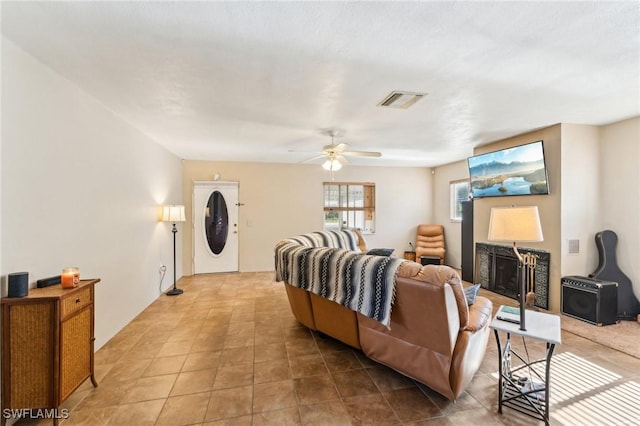 living room with ceiling fan and light tile patterned floors