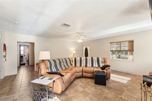 living room featuring light tile patterned flooring and ceiling fan