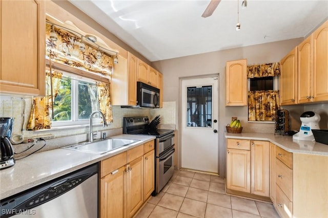 kitchen with sink, light tile patterned floors, stainless steel appliances, light brown cabinetry, and decorative backsplash