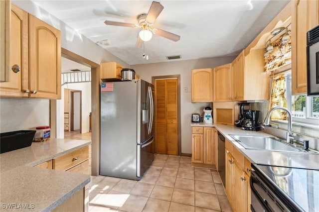 kitchen with ceiling fan, appliances with stainless steel finishes, sink, and light brown cabinetry