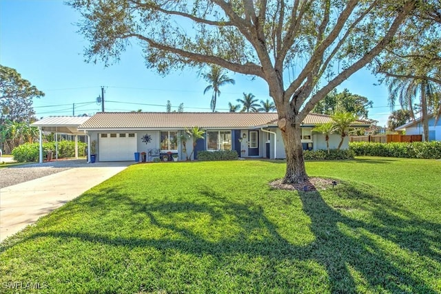 ranch-style home with a garage, a front lawn, and a carport