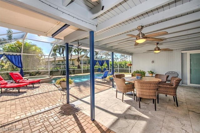 sunroom featuring ceiling fan