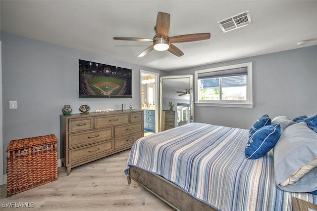 bedroom with ceiling fan, ensuite bathroom, and light hardwood / wood-style flooring