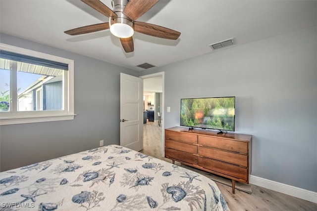 bedroom with ceiling fan and light wood-type flooring