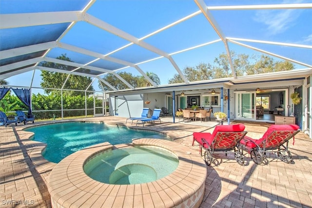 view of swimming pool featuring a lanai, a patio area, ceiling fan, and an in ground hot tub