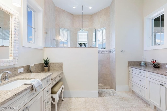 bathroom featuring vanity and a tile shower