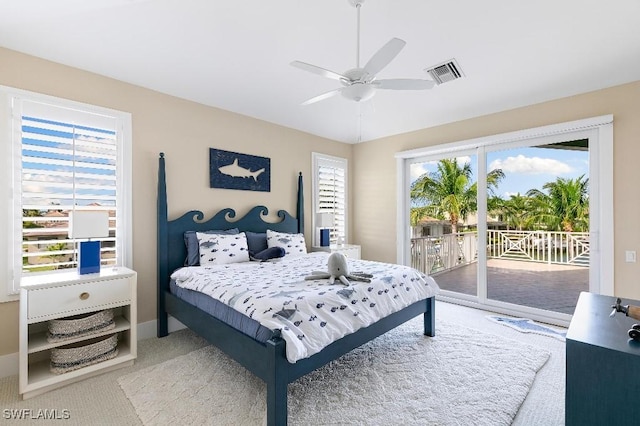 carpeted bedroom featuring access to exterior and ceiling fan