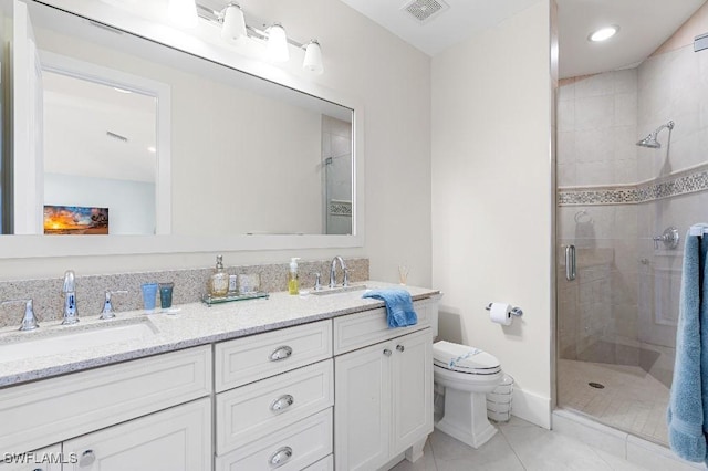 bathroom featuring vanity, a shower with shower door, tile patterned floors, and toilet