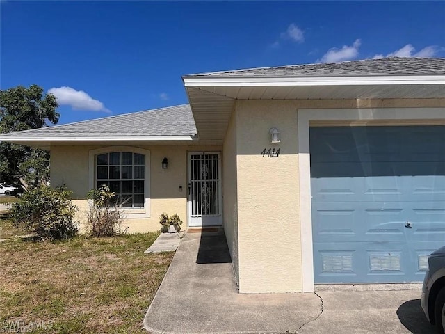 view of exterior entry with a garage