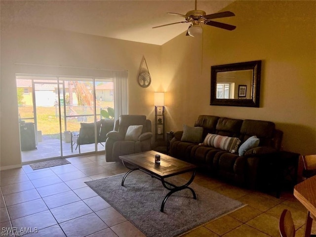 tiled living room with ceiling fan and high vaulted ceiling